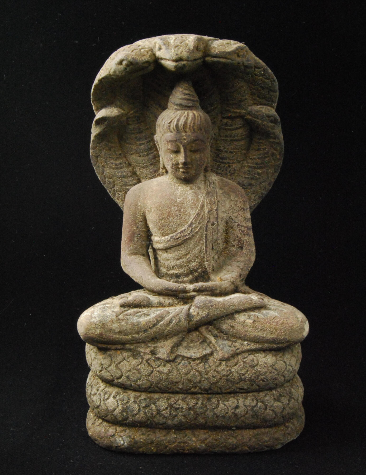 Patañjali Clay sculpture of Patañjali author of Yoga Sutra seated in full lotus, hands in meditation Mudra, eyes lowered, with a multi-serpent hood rising behind him representing the many tools of yoga.